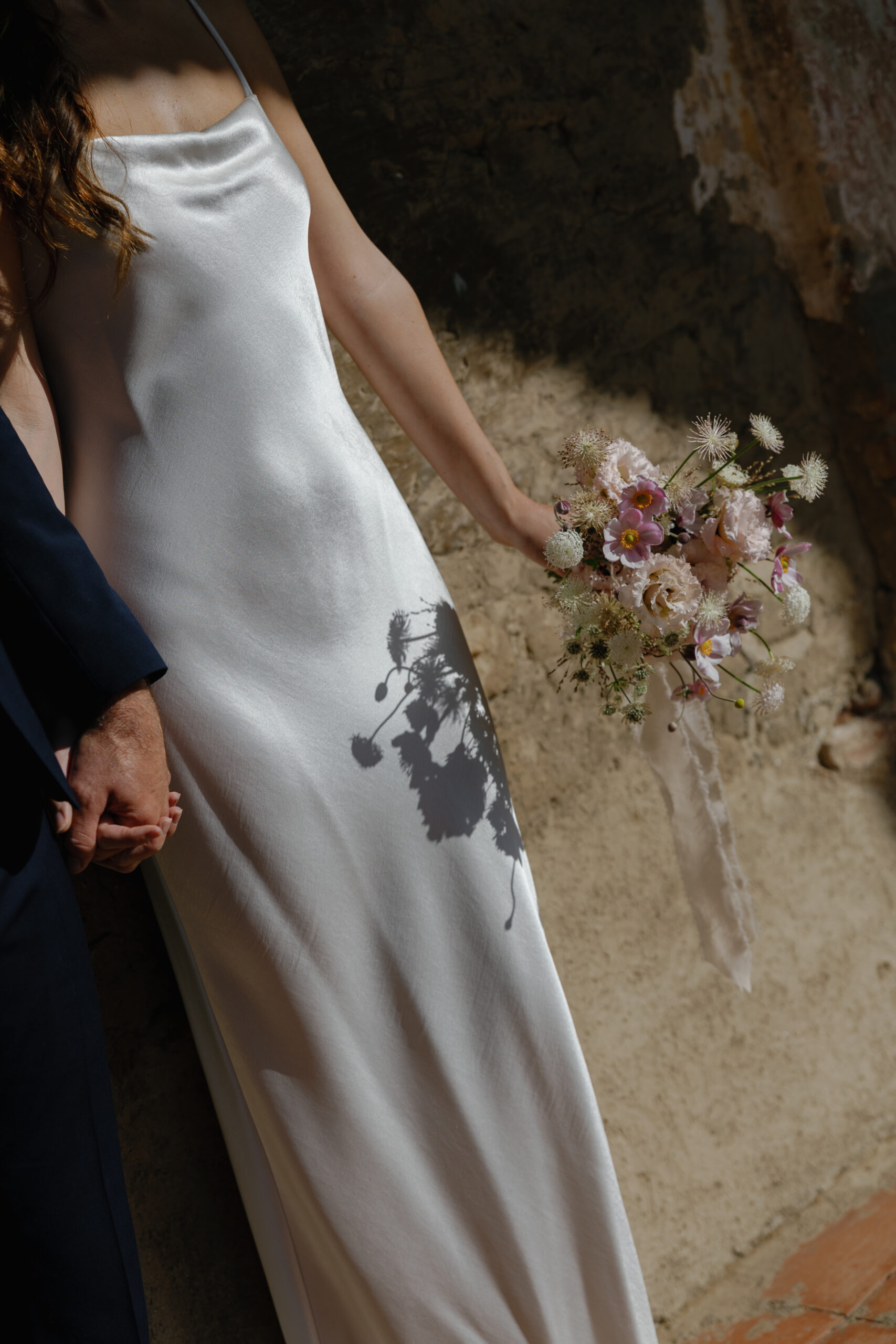 wedding dress under the sun light at the beautiful historical mission at san juan capistrano